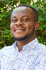 Raymond Tetteh, Graduate research assistant headshot in front of green foliage