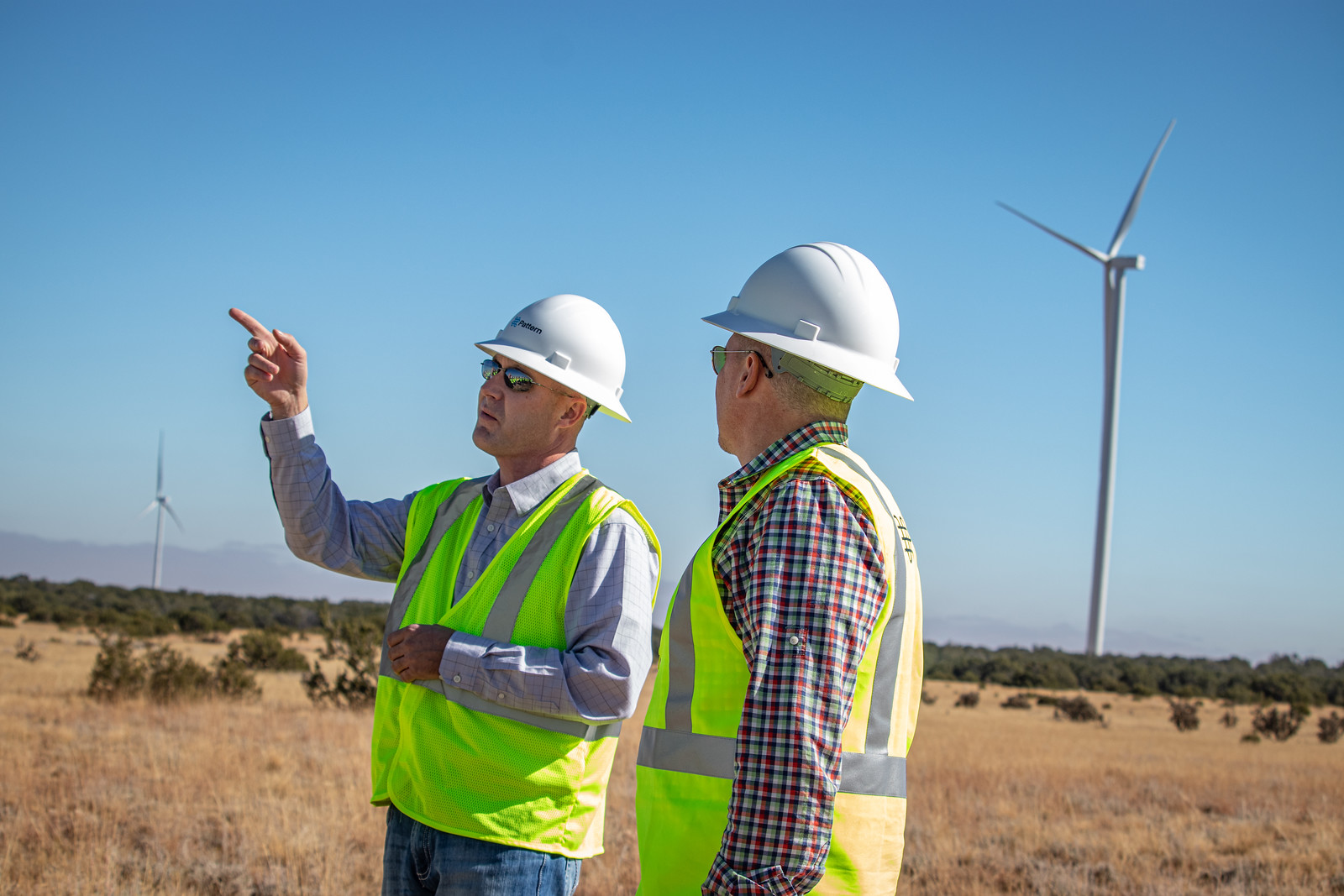 men visiting during wind turbine field day